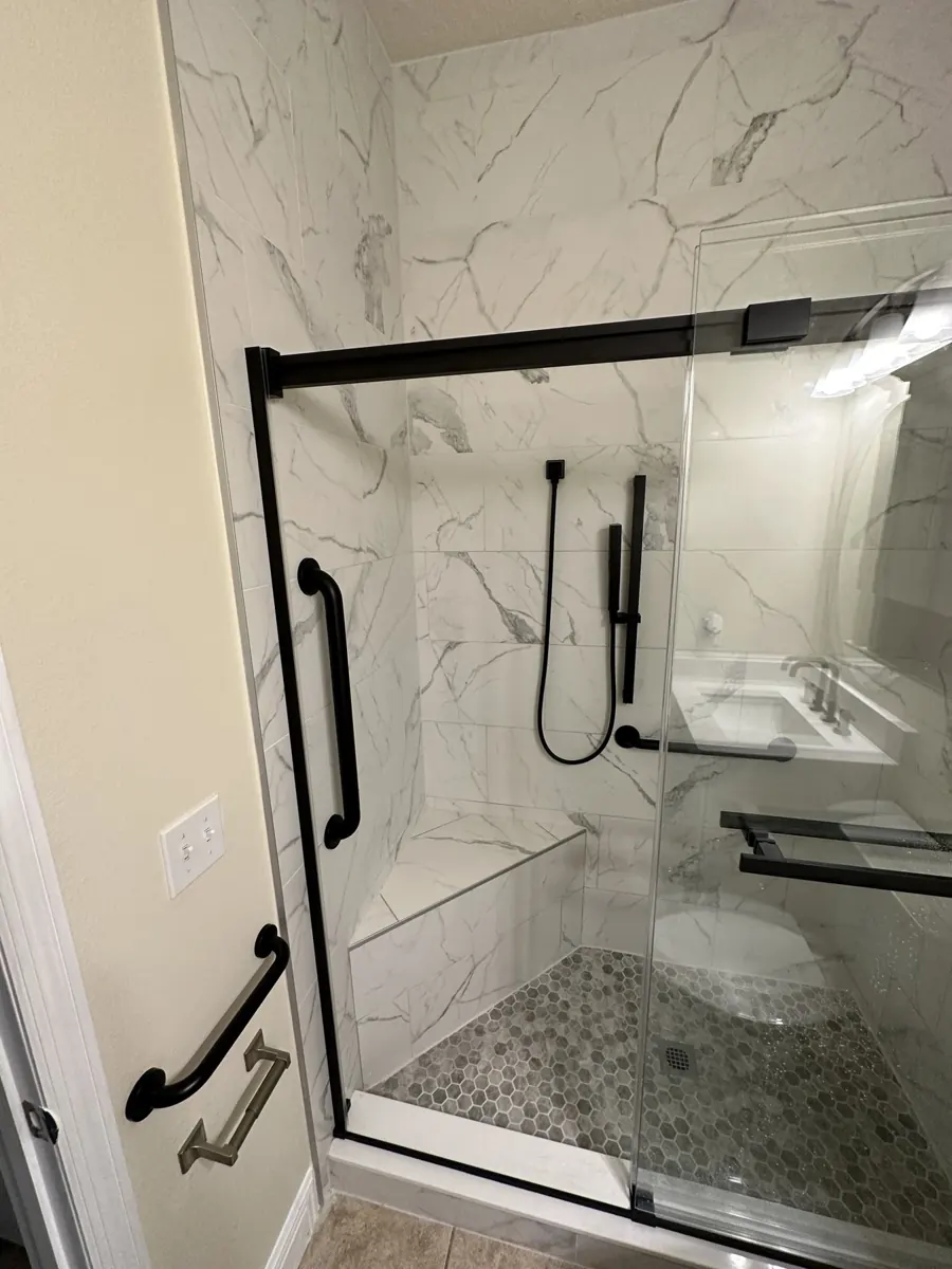 Glass-enclosed marble-look shower