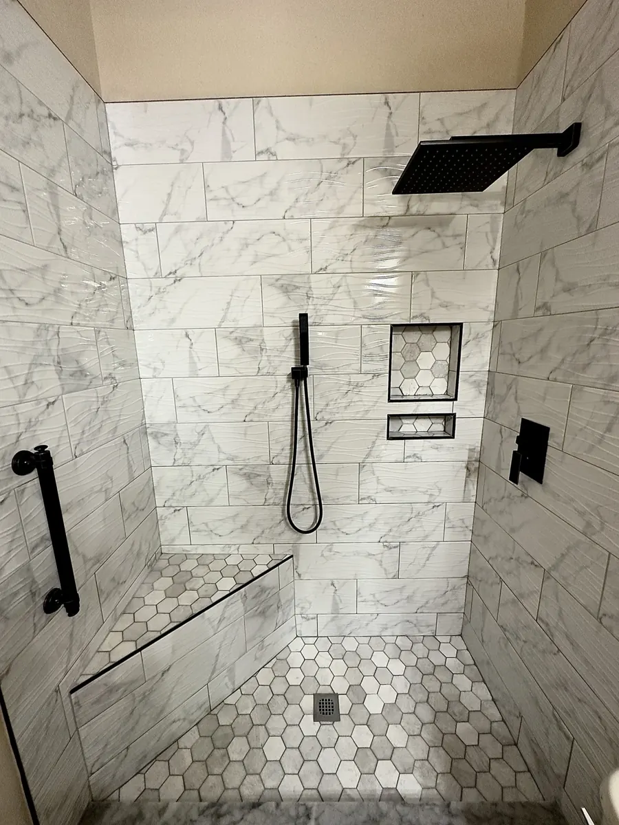 Marble-look shower with black fixtures